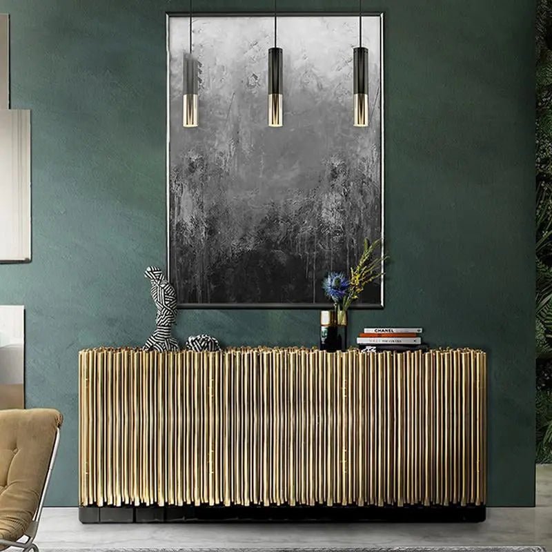 Symphony Contemporary Sideboard with gold ribbed panels on a dark green wall, paired with art and pendant lighting.