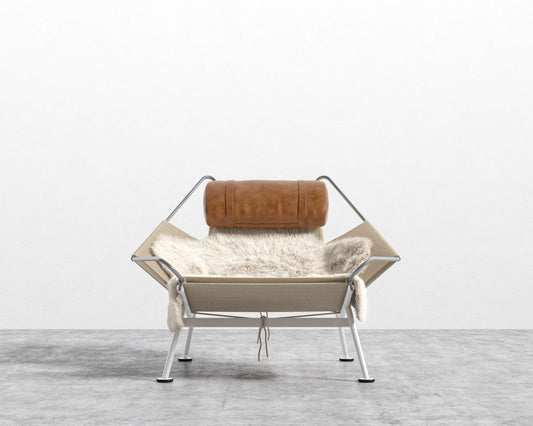 A Flag Halyard chair with Ottoman with a steel frame, leather backrest, and plush fur seat cushion set against a plain white background.