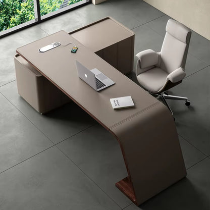 Urban Ashram Arden executive desk wrapped in taupe saddle leather with a curved silhouette and integrated charging.