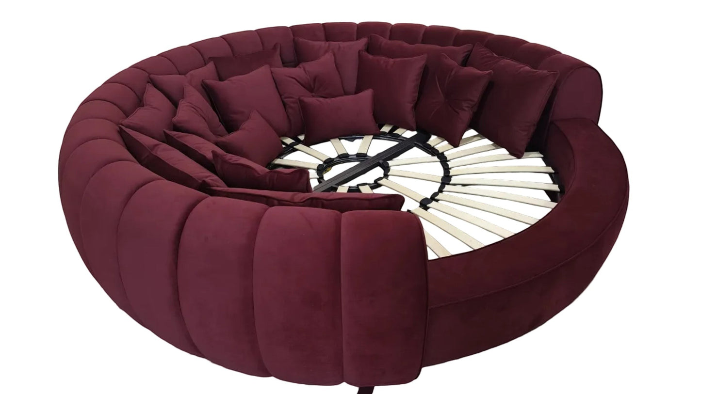 Urban Ashram round velvet movie bed in deep burgundy with plush cushions and a slatted wooden base for luxury lounging