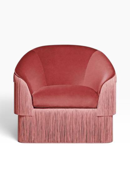 Urban Ashram Atelier fringe armchair in dusty rose velvet with a curved backrest and cascading side fringe detail.