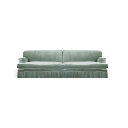 Urban Ashram vintage-style three-seat sofa in green velvet with elegant tassel fringe and rounded armrests.