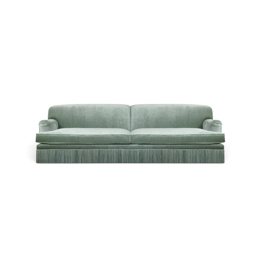 Urban Ashram vintage-style three-seat sofa in green velvet with elegant tassel fringe and rounded armrests.