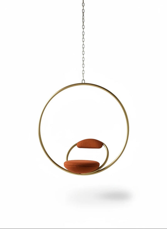 Urban Ashram Hanging Hoop Chair in brushed brass with red Kvadrat wool upholstery, featuring a geometric design.