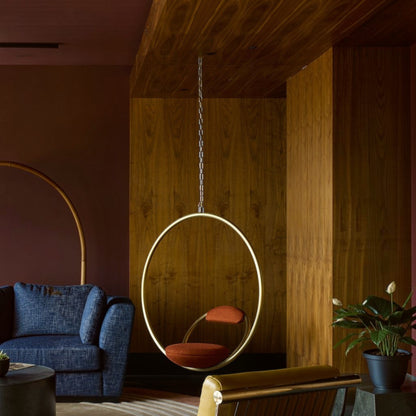 Urban Ashram Hanging Hoop Chair by Lee Broom featuring a brushed brass circular frame and red Kvadrat wool upholstery.