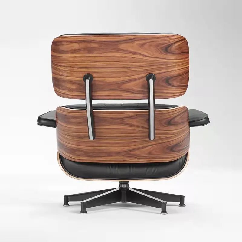 Urban Ashram mid-century lounge chair and ottoman featuring black leather upholstery and a curved walnut wood shell.
