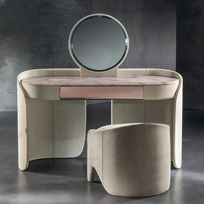Urban Ashram Aveline vanity set with pink-veined marble top, curved beige frame, circular mirror, and matching stool.