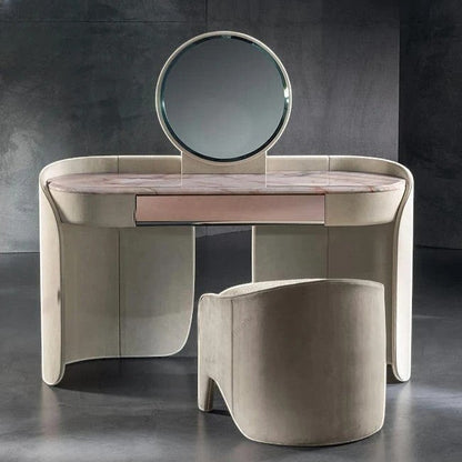 Urban Ashram Aveline vanity set with pink-veined marble top, curved beige frame, circular mirror, and matching stool.