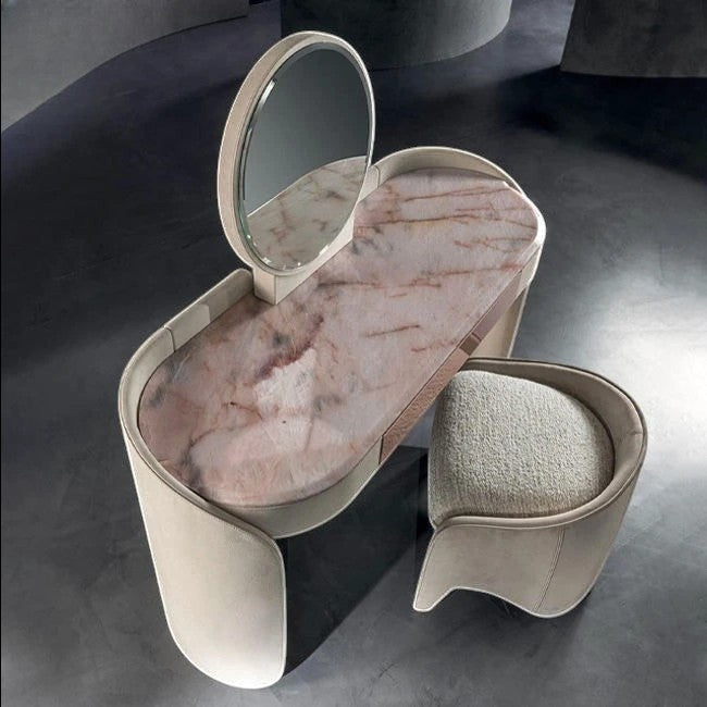 Urban Ashram Aveline vanity set with pink veined marble top, curved base, circular mirror, and upholstered stool.