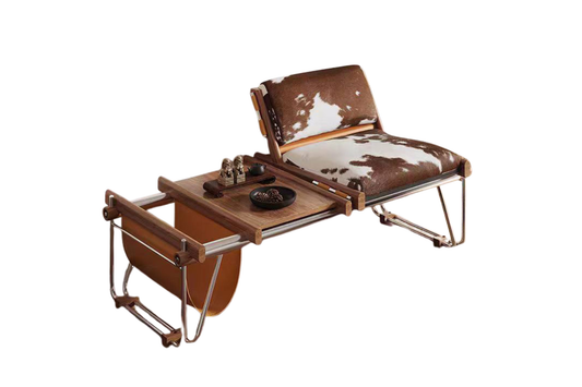 Urban Ashram Ronan lounge chair with brown and white cowhide upholstery and polished steel frame with wooden side table