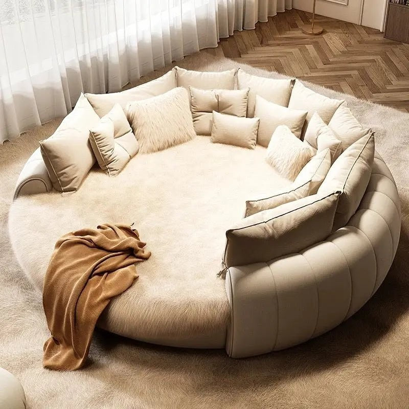Urban Ashram round Dream Lounger movie bed in cream faux fur with plush cushions on a matching area rug