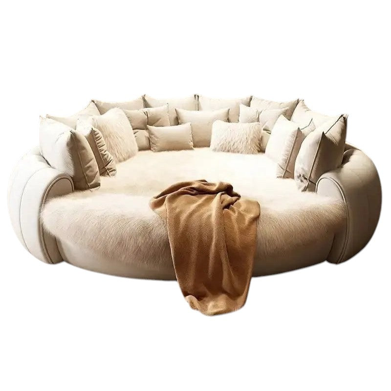 Urban Ashram Dream Lounger round movie bed in cream with plush faux fur and decorative cushions in a luxury room.