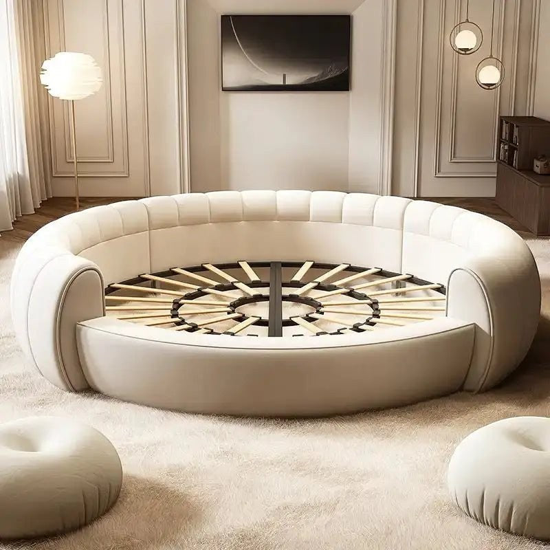 Urban Ashram Dream Lounger round movie bed with cream upholstery and a slatted wooden base in a modern living room.