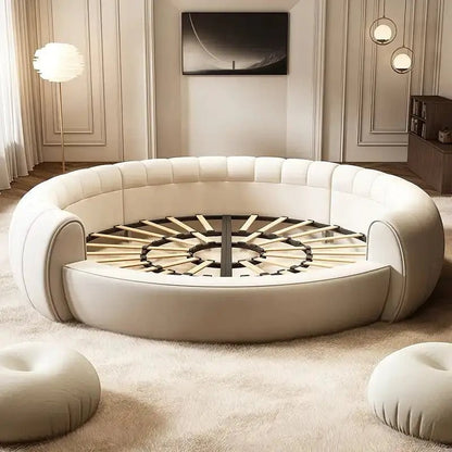 Urban Ashram Dream Lounger round movie bed with cream upholstery and a slatted wooden base in a modern living room.