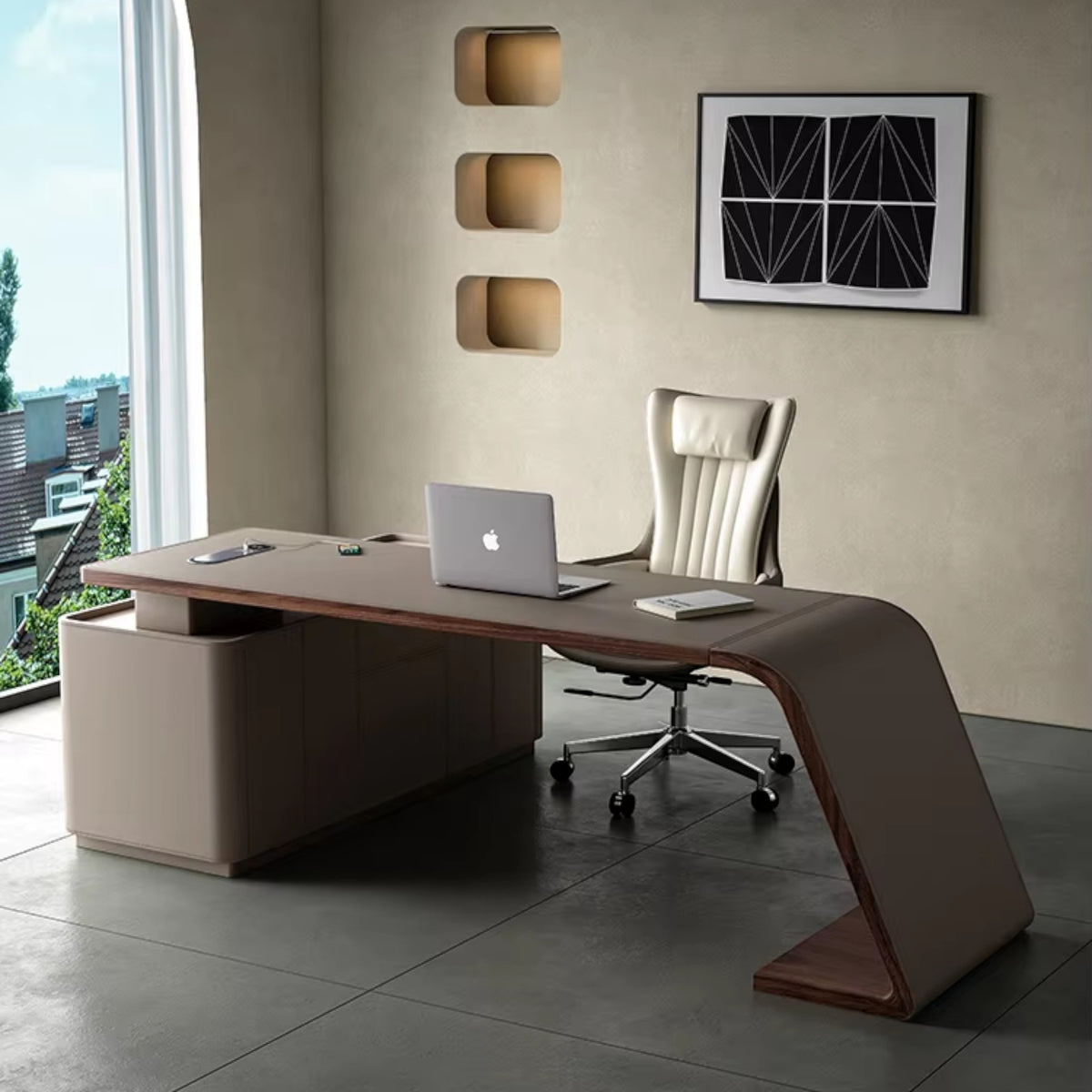 Urban Ashram Arden saddle leather executive desk with a curved architectural silhouette and integrated storage.