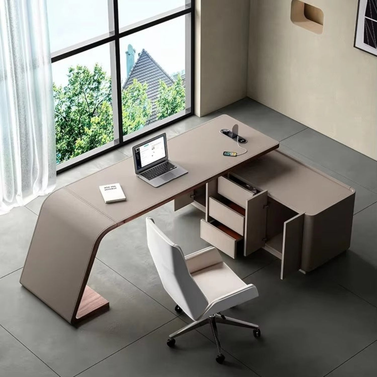 Urban Ashram Arden saddle leather executive desk with curved silhouette, integrated storage, and charging ports.