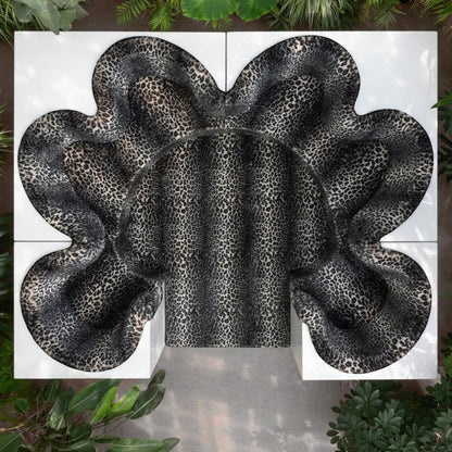 Urban Ashram Savanna modular sectional sofa featuring a sculptural, curved design with a bold leopard print fabric.