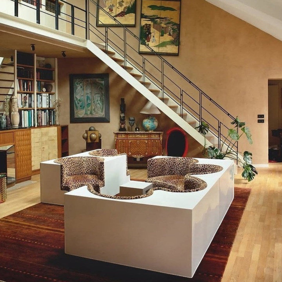 Urban Ashram Savanna modular sectional sofa with white architectural base and leopard print curved seating elements.