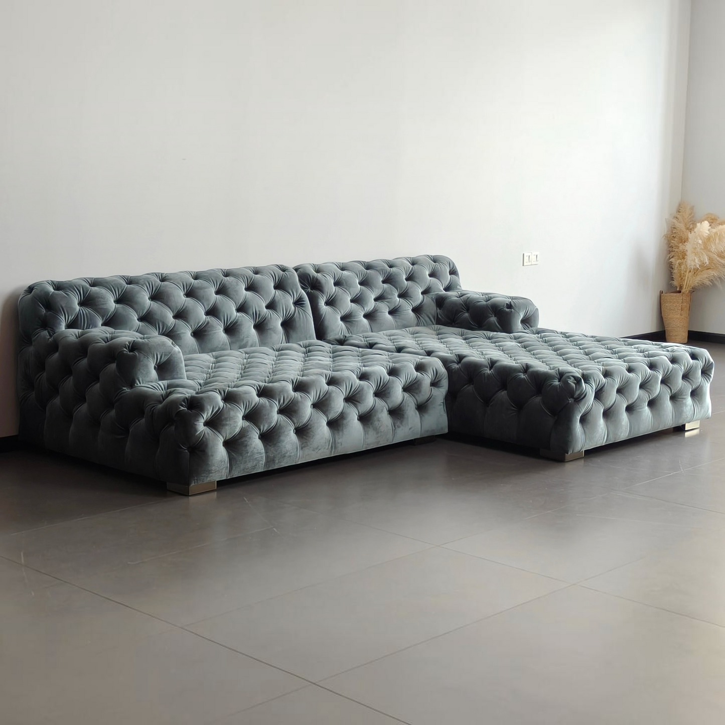 Urban Ashram Coco Miralda smoke grey velvet Chesterfield sectional sofa with deep button tufting and angled backrest.