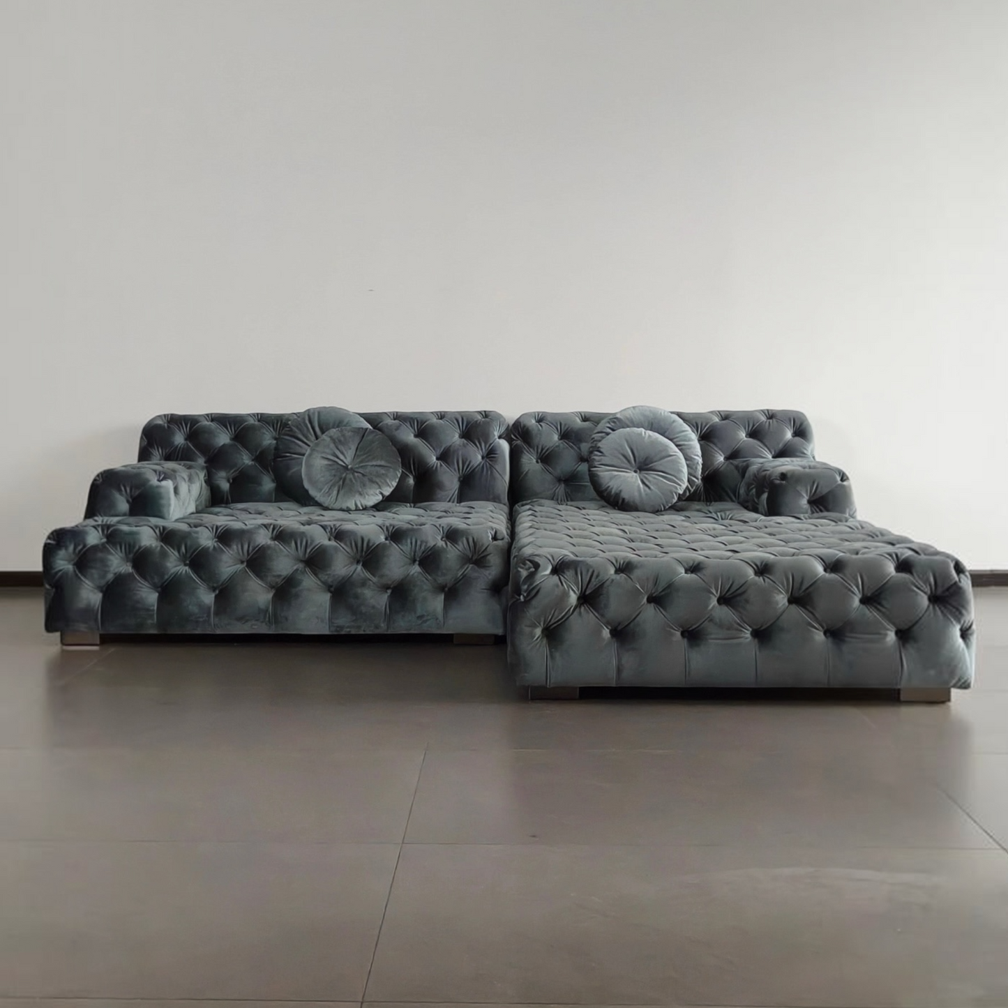 Urban Ashram Coco Miralda smoke grey velvet Chesterfield sofa with button tufting and round cushions in a modern room