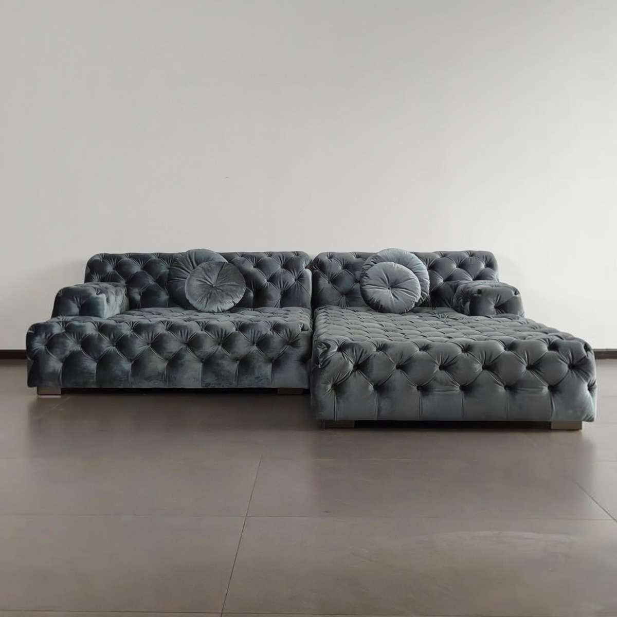 Urban Ashram Coco Miralda smoke grey velvet Chesterfield sofa with button tufting and round cushions in a modern room