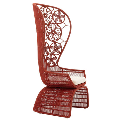 Urban Ashram Genevieve high-back armchair in terracotta with intricate floral woven backrest and cream seat cushion.